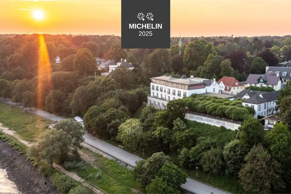 A building surrounded by trees under a clear sky.